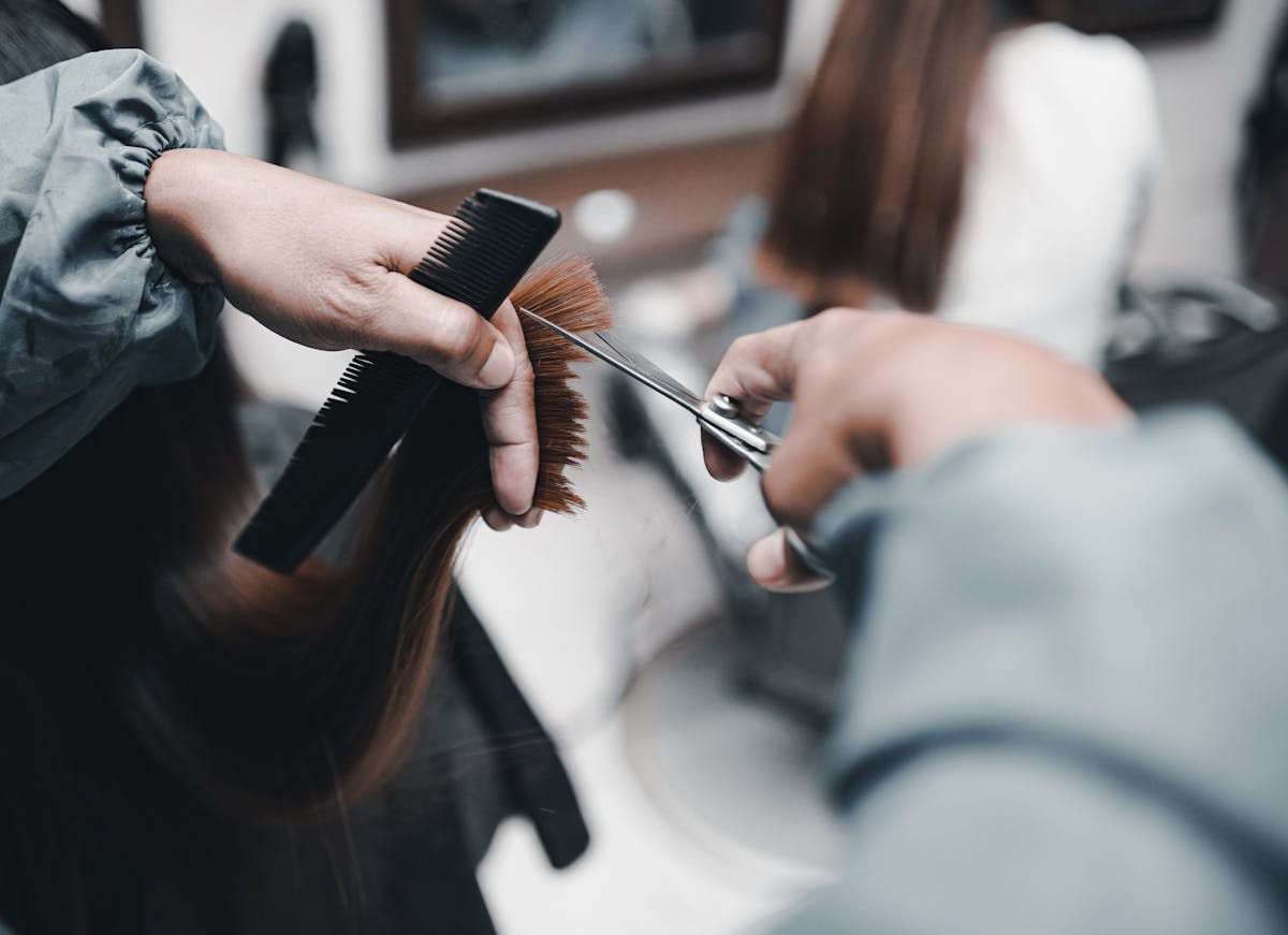Hair stylist cutting hair in a salon